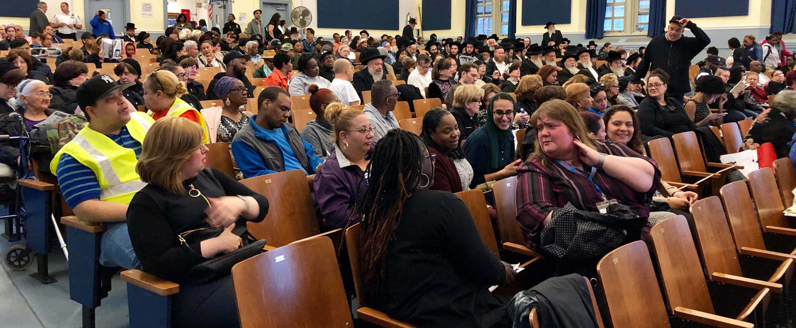 Photo of residents at an Omni NY community meeting in a school auditorium